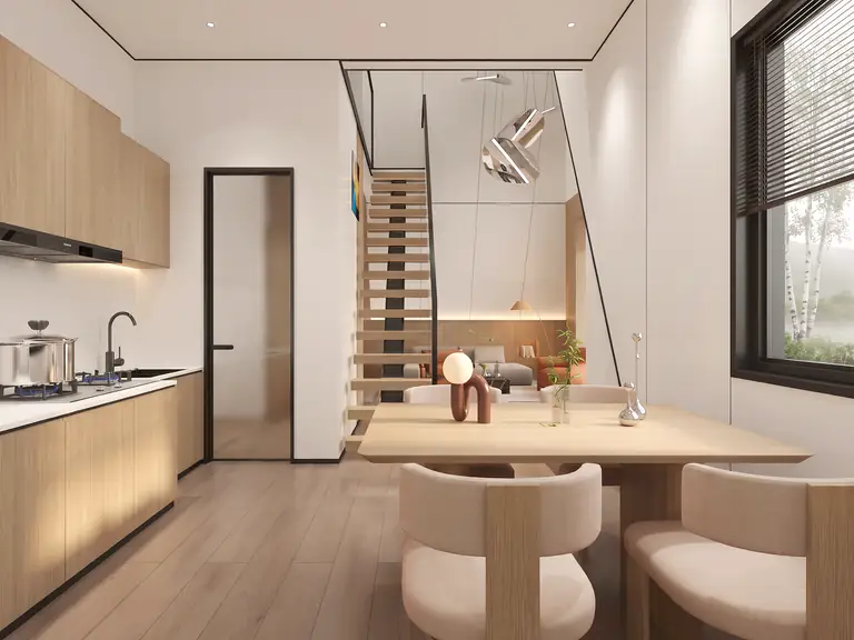 Prism kitchen along the wall with a dining table and stairs to the second level